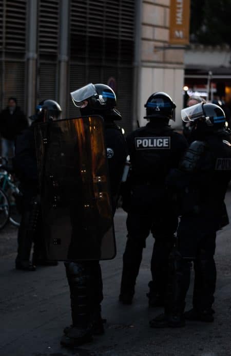 men wearing Police uniforms standing outside buildings at daytime
